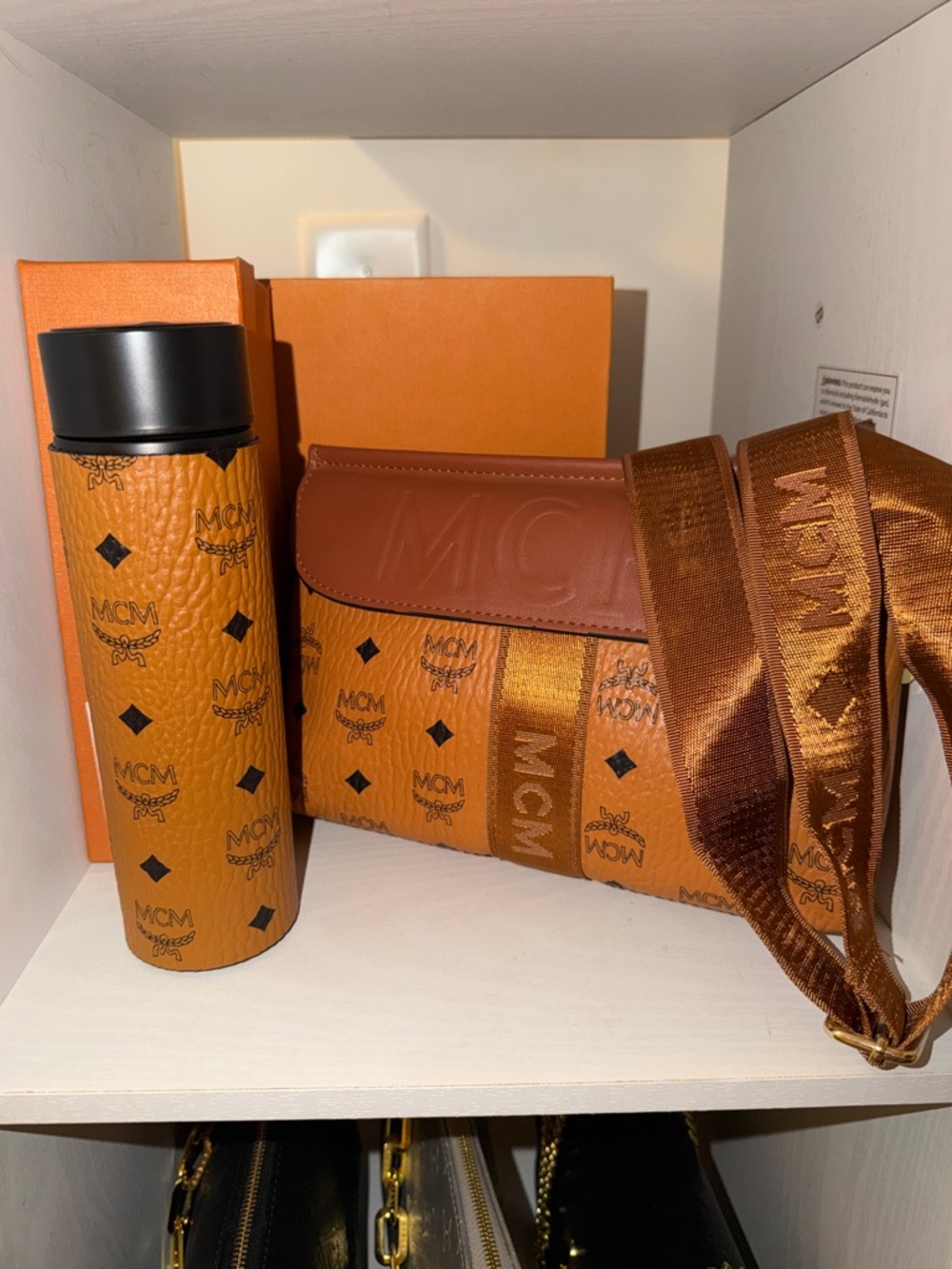 MCM water bottle and Cognac Monogram Messenger Bag with Strap